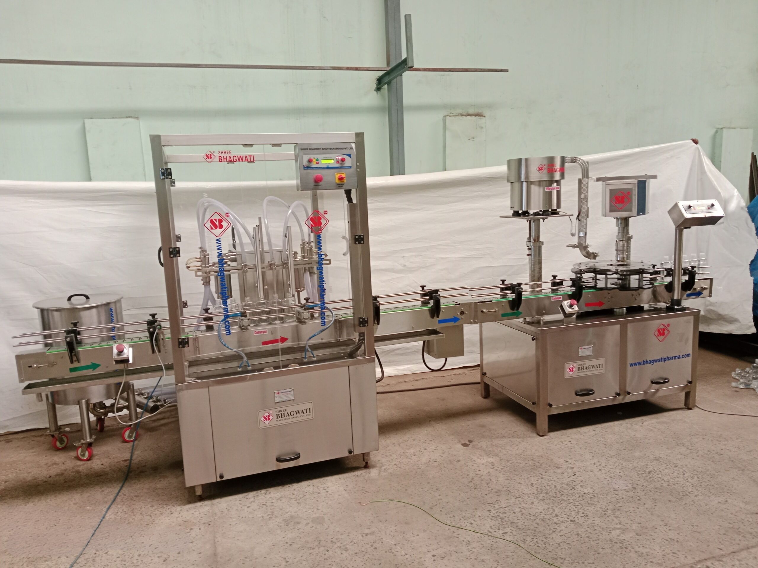 Liquid bottle filling and screw capping machine